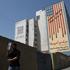 A man walks near an anti-U.S. mural on a building in Tehran