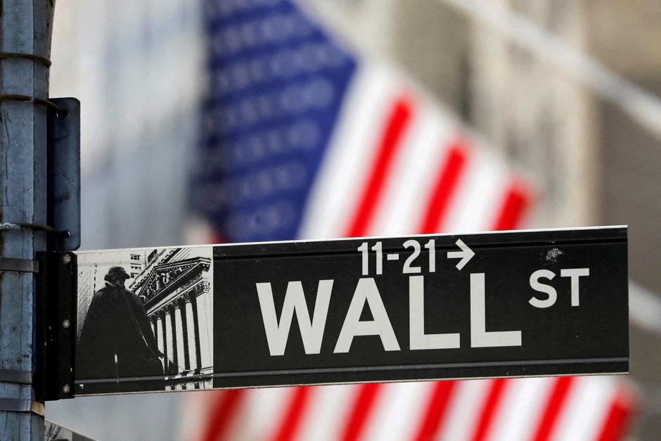 FILE PHOTO: A street sign for Wall Street is seen outside the New York Stock Exchange (NYSE) in New York City | Author: Andrew Kelly