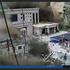 A CCTV footage shows people running away as wall of mud and water destroys buildings in a valley at Nepal-China border, in Gyirong