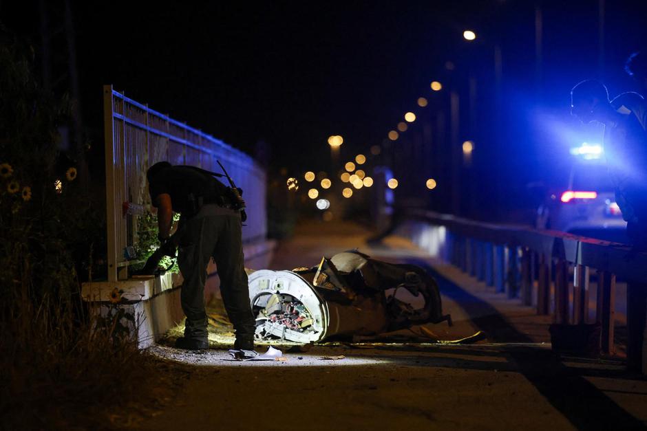 Israeli security and rescue personel work next to a part of a projectile following a Missile attack from Iran towards Israel in northern Israel | Author: SHIR TOREM/REUTERS