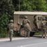 Israeli soldiers go back to their vehicle after they went to shelter during sirens for a drone attack from Lebanon towards Israel at the Israeli side of the Israel Lebanon border