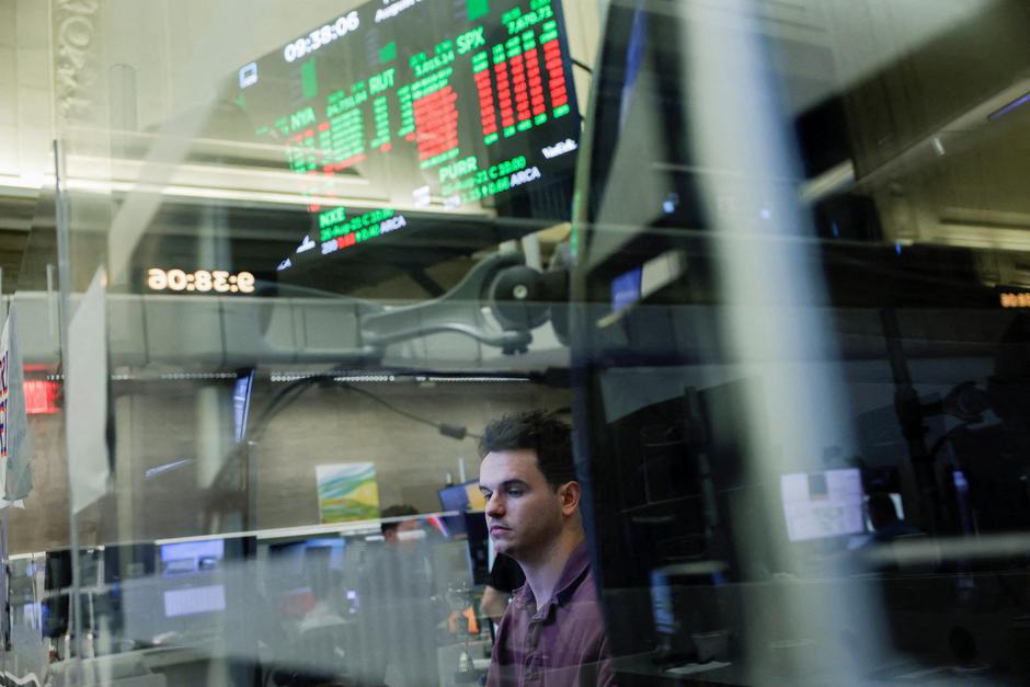 FILE PHOTO: A futures-options trader works on the floor at the New York Stock Exchange (NYSE) in New York City | Author: Jeenah Moon