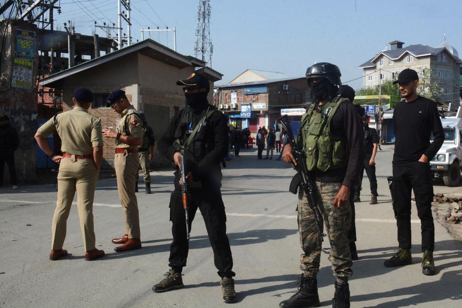 Indian police officers stand guard outside the police control room in Srinagar