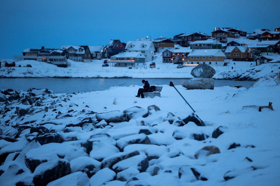 A man sits on a bench by the sea at Nuuk's old harbour | Author: Marko Djurica