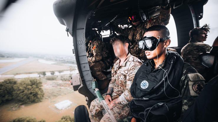A Royal Thai Army Special Forces Soldier (right) and a U.S. Army Soldier, 1st Special Forces Group (Airborne) (left) prepare to jump from a UH-60 Blackhawk helicopter as part of helo-cast training during Hanuman Guardian 2022 in Lopburi, Kingdom of Thaila