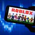 LONDON, UK - March 2021: Roblox game logo in front of stock market chart