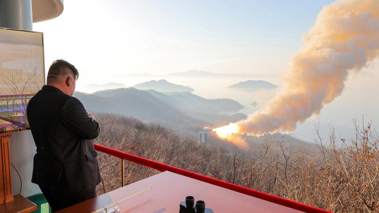 North Korea's Kim Jong Un observes a ground ejection test of a high-output solid-fuel engine using carbon fiber composite materials