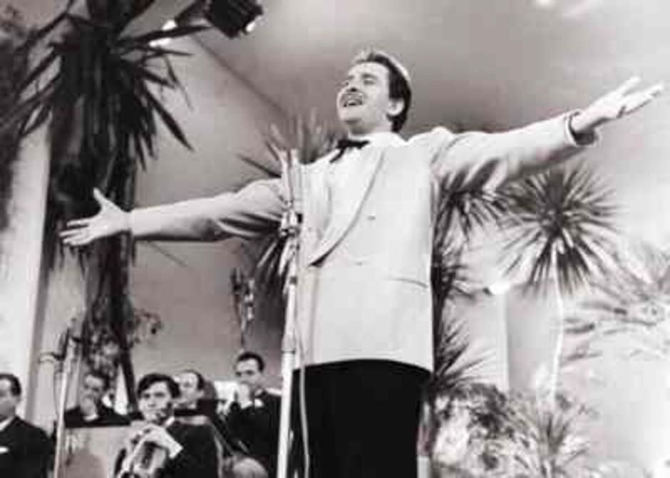 This image shows Italian singer Domenico Modugno performing at the 1958 Sanremo Festival, an important Italian music competition, where he became famous for 'Nel blu dipinto di blu.' | Author: Profimedia