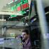 FILE PHOTO: A futures-options trader works on the floor at the New York Stock Exchange (NYSE) in New York City