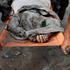 Members of a rescue team carry the body of a victim following devastating floods, in Trishuli