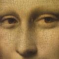 This famous detail of the *Mona Lisa*, painted by Leonardo da Vinci, highlights the enigmatic eyes of the subject. The portrait, housed in the Louvre, is renowned for its intricate rendering and the mysterious expression of the sitter, which has intrigued
