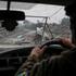 A Ukrainian serviceman drives a vehicle in the frontline town of Druzhkivka