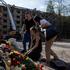 People commemorate victims at site of a Russian missile strike on a residential area in Kyiv