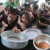 FILE PHOTO: Palestinians gather to receive food cooked by a charity kitchen, amid the Israel-Hamas conflict, in the northern Gaza Strip