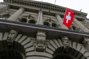 FILE PHOTO: A Swiss flag hangs at the Swiss Parliament building (Bundeshaus) in Bern