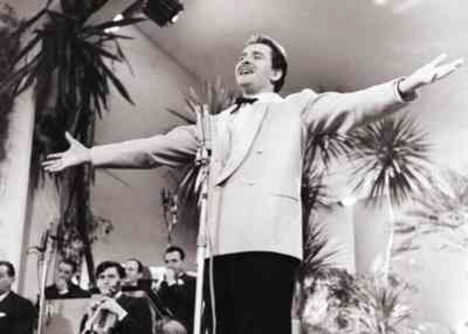 This image shows Italian singer Domenico Modugno performing at the 1958 Sanremo Festival, an important Italian music competition, where he became famous for 'Nel blu dipinto di blu.'