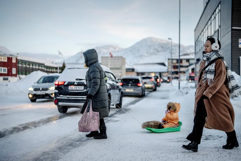 A person pulls a child on a snow sled, in Nuuk | Author: Mads Claus Rasmussen