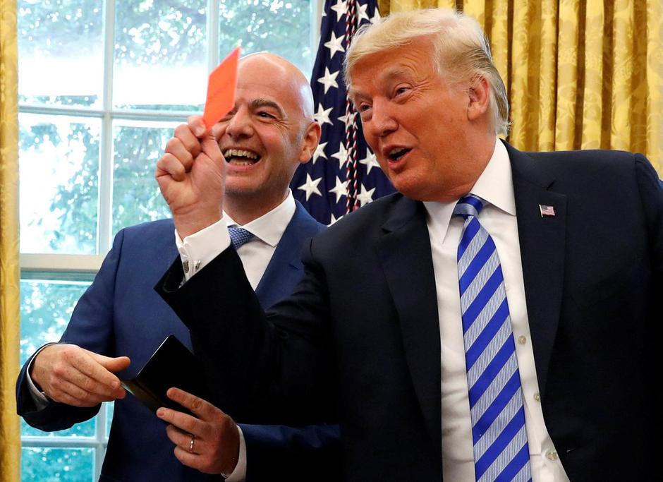 FILE PHOTO: U.S. President Donald Trump holds red card as he meets with FIFA President Infantino in the Oval Office of the White House in Washington | Author: LEAH MILLIS/REUTERS