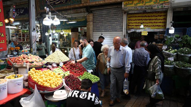 People walk at Tajrish Bazaar in Tehran