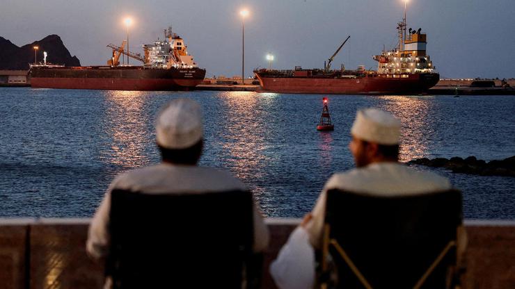 FILE PHOTO: Galaxy Globe bulk carrier and Luojiashan tanker sit anchored in Muscat