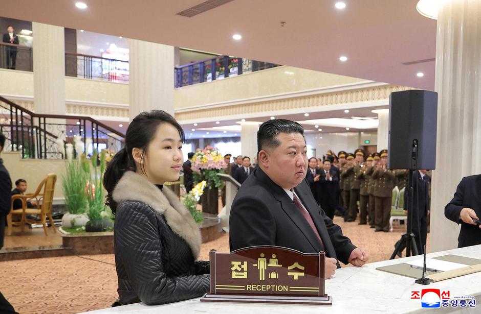 North Korean leader Kim Jong Un and his daughter Kim Ju Ae stand at a hotel reception counter as they attend an inauguration ceremony for hotels in the tourist resort in Samjiyon City | Author: KCNA/REUTERS