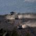 Israeli military vehicles manoeuvre along the Israel-Lebanon border as seen from northern Israel