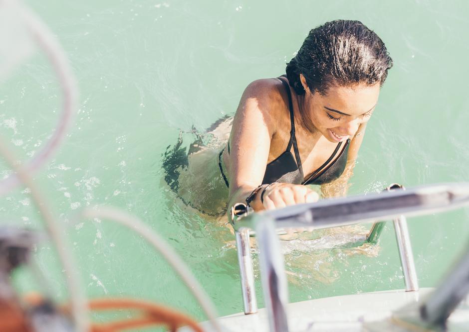 Djevojka se penje na jahtu nakon kupanja | Author: Thinkstock