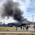 Smoke rises from a convenience store at a gas station, amid the clashes between Thailand and Cambodia, in Kantharalak district