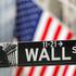 FILE PHOTO: A street sign for Wall Street is seen outside the New York Stock Exchange (NYSE) in New York City