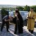 A man kisses Archbishop Marchel's hand as he arrives for his Mass at a church in Slobozia-Magura