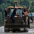 A survivor is transported to a safer place in heavy machinery following flash flood and mudslide at Trishuli