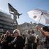 Banksy Confirms latest artwork In Waterloo Place, Westminster, England, United Kingdom Tourists gather underneath the satirical statue, which depicts a man marching off a precipice while blinded by a massive flag, which has appeared outside the Athenaeum