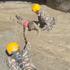 Rescuers evacuate a person from a tunnel of a hydropower project, in the aftermath of flash floods and a mudslide, in Rasuwa