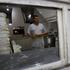 A baker carries bread in a bakery in Tehran