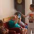 Residents at the house for elderly persons are refreshed by a staff member with a mist moisturiser, as a heat wave hits Europe, in Chatelet