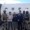FILE PHOTO: Handout photo of Efrain Antonio Campo Flores and Franqui Fancisco Flores de Freitas stand with Haitian law enforcement officers in this November 12, 2015 photo after their arrest in Port Au Prince, Haiti.