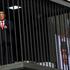 Person dressed up as US President Donald Trump performs inside mock prison cell in Tehran