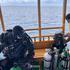 A diver from Finland takes part in a recovery operation for last two bodies of Italian scuba divers near Vaavu Atoll