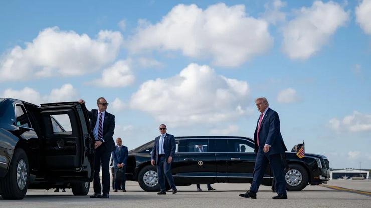 President Donald J. Trump arrives at Miami Beach for the FII PRIORITY Summit, March 27, 2026, stepping from a motorcade vehicle as Secret Service agents stand by on the tarmac. Image courtesy of the White House.