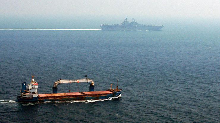 A merchant ship sails off the starboard side of amphibious assault ship USS Kearsarge (LHD 3) while transiting the Straits of Hormuz. Kearsarge is surge-deployed transporting elements of the 24th Marine Expeditionary Unit in support of Operation Iraqi Fre