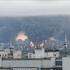 Thick plumes of smoke with flames rise from an oil refinery in Moscow