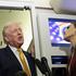 U.S. President Donald Trump speaks to reporters aboard Air Force One en route from Florida to Joint Base Andrews