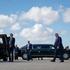 President Donald J. Trump arrives at Miami Beach for the FII PRIORITY Summit, March 27, 2026, stepping from a motorcade vehicle as Secret Service agents stand by on the tarmac. Image courtesy of the White House.