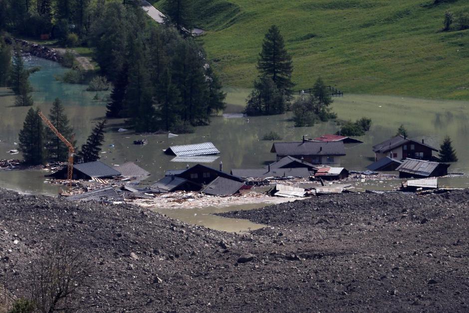 A few remaining houses are seen after a massive rock and ice slide covered most of the village of Blatten | Author: Stefan Wermuth/REUTERS