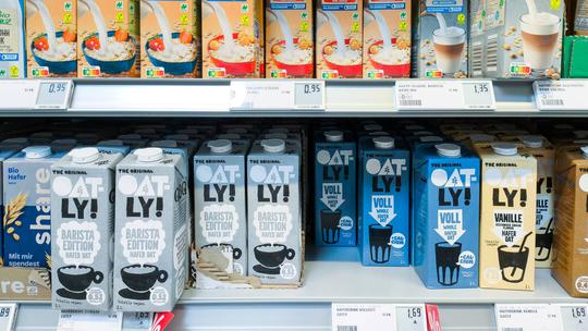 Bavaria, Germany - August 12, 2024: Selection of vegan milk alternatives, including oat drinks from brands such as Oatly