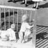 A historical photograph of children playing in a sandbox at the Hurdal Verk orphanage, Norway, depicting the post-war era and the Lebensborn program during the German occupation of Norway in World War II.