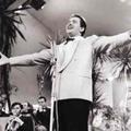 This image shows Italian singer Domenico Modugno performing at the 1958 Sanremo Festival, an important Italian music competition, where he became famous for 'Nel blu dipinto di blu.'