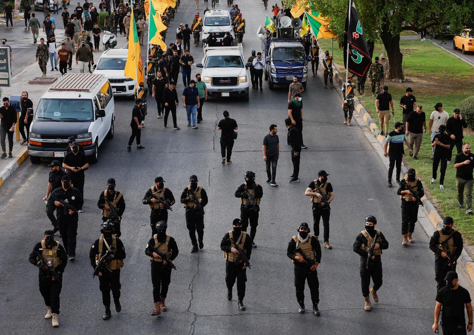 FILE PHOTO: A vehicle carries the coffin of a commander from Iraq's Kataib Hezbollah armed group, in Baghdad | Author: Thaier Al-Sudani