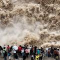 YAN AN, CHINA - SEPTEMBER 20: Tourists visit the Hukou Waterfall on the Yellow River as water volume significantly incre