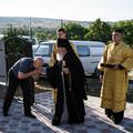 A man kisses Archbishop Marchel's hand as he arrives for his Mass at a church in Slobozia-Magura